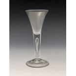 A tear drop wine glass, circa 1760, the trumpet bowl on a single tear drop stem and conical foot,