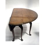 Stuart Linford, a bespoke burr elm wake table, broad top with twin oval drop flaps, eight gateleg