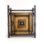 An Arts and Crafts oak smoker's compendium, circa 1910, carved frame, single door with turquoise