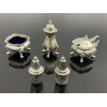 A George VI silver three piece cruet together with a pair of Victorian pepper pots