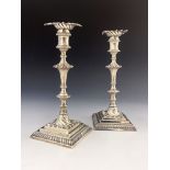 A pair of George III cast silver candlesticks, Ebenezer Coker, London 1770