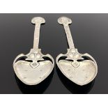 A pair of Arts and Crafts silver spoons, TW, Birmingham 1901, the planished spade bowls on open