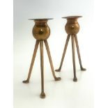 Keswick School of Industrial Art, a pair of copper candlesticks, tripod bases, bud holders,