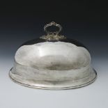 A large Edwardian oval plated domed dish cover, scroll handle secured by a wingnut, 50 by 38cm