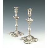 A pair of George III cast silver candlesticks, Ebe