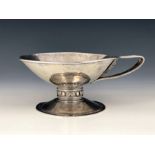 An Arts and Crafts white metal single handled cup