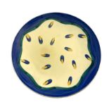Susie Cooper, an Art Deco plate, 1930s, painted with randomly scattered blue and yellow lozenges,