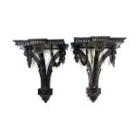 A pair of late 19th Century mahogany wall brackets, of breakfront form with dentil friezes, carved