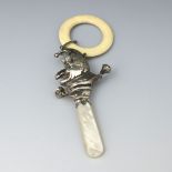 An Elizabeth II novelty silver baby's teething rattle, W.H. Collins & Co, Chester 1959, formed as Mr