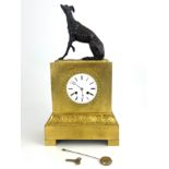 A French ormolu bracket clock, circa 1870, surmounted with a bronze model of a seated greyhound,