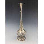 A Chinese silver rosewater sprinkler, footed, bulbous form, embossed with cartouches of peonies