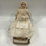 An early 20th Century French bisque head doll, blonde wig, sleeping eyes, open mouth and pierced