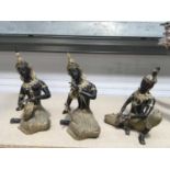 A set of three decorative gilt metal and bronzed Thai deities, seated playing musical instruments,