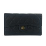 Chanel, a quilted wallet, featuring a diamond quilted black caviar leather exterior, with a rear