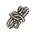 An 18ct gold diamond and black diamond cocktail ring, designed as an abstract openwork scroll, total