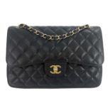 Chanel, a Jumbo Classic Double Flap handbag, featuring the maker's signature black quilted caviar