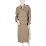 Burberry, a ladies trench coat, featuring double breasted front button fastenings, buttoned