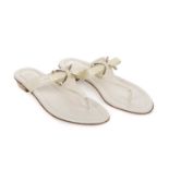 Christian Dior, a pair of unworn thong sandals, crafted from cream leather, with pale gold-tone