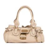 Chloe, a cream Paddington handbag, crafted from beige leather, with brushed gold-tone hardware, dual