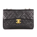 Chanel, a Maxi Jumbo XL Flap handbag, crafted from black quilted lambskin leather, with gold-tone