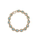 An Edwardian 9ct gold turquoise cabochon line bracelet, with split pearl line spacers and lobster