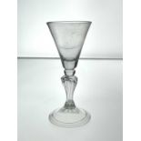 A Dutch hollow baluster wine glass, circa 1740, the concial bowl on a knopped heaxagonal moulded