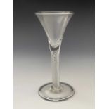 An air twist wine glass, circa 1750, the trumpet bowl on a single series multi spiral stem and