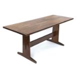 Peter Waals, an oak refectory table, circa 1930, tapered plank supports united by a plank stretcher,