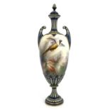 A Hadleys Worcester twin handled vase and cover, relief moulded pedestal urn form, painted with a