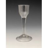 A plain stemmed wine glass, circa 1740, the ogee bowl on cylindrical stem and conical folded foot,