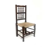 A 19th Century country side chair, double row spindle back, rush seat, baluster turned stretcher,