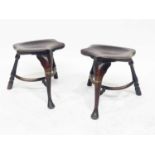 A pair of traditional elm cock fighting stools, dished seats, cabriole legs, pad feet, hoop