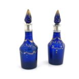 A pair of silver mounted blue and gilt glass condiment bottles