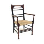 An Arts & Crafts side armchair, bar back, ring-turned arm supports and legs, rush seat, spindle