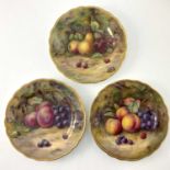 H Lockyer for Royal Worcester, three fruit painted plates, ogee gilt borders, decorated with still