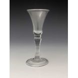 A balustroid wine glass, circa 1740, the bell shaped bowl on a basal knopped inverse baluster