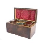 A George III flame mahogany and boxwood strung tea caddy, circa 1810, rectangular form with copper