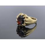 A 9 carat gold and garnet ring, claw set oval stone, size R, 6.3g