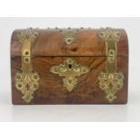 A mid Victorian figured walnut tea caddy, circa 1860, domed hinged cover with fretwork brass