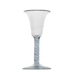 A colour twist wine glass, circa 1760, the bell shaped bowl on a blue and opaque double strand and
