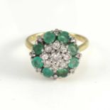 An 18ct gold emerald and diamond set cluster ring size L