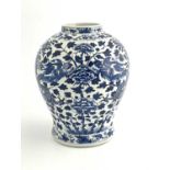 A Chinese blue and white temple vase, inverse baluster form, painted with dragons and peony