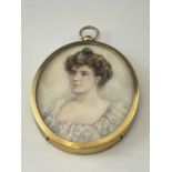An Edwardian portrait miniature, oval bust length of a woman in lace trimmed dress, brown hair,