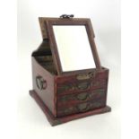 An Oriental lacquer dressing table box, the double hinged lid with folding mirror above three