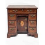 A George II mahogany crossbanded and strung kneehole desk, circa 1760, moulded edge top with central