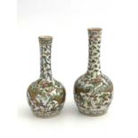 A near pair of Chinese Doucai style vases, globe and shaft bottle form, decorated with gilt