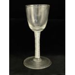 An opaque twist wine glass, circa 1760, the round funnel bowl on a double series quadruple strand