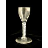 An opaque and air twist wine glass, circa 1760, the rounded bowl on a double strand ribbon twist and