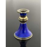 A Continental silver gilt and blue enamel miniature candlestick