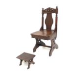 A late 19th Century oak hall chair of Gothic Revival design, fretwork pediment top rail, turned